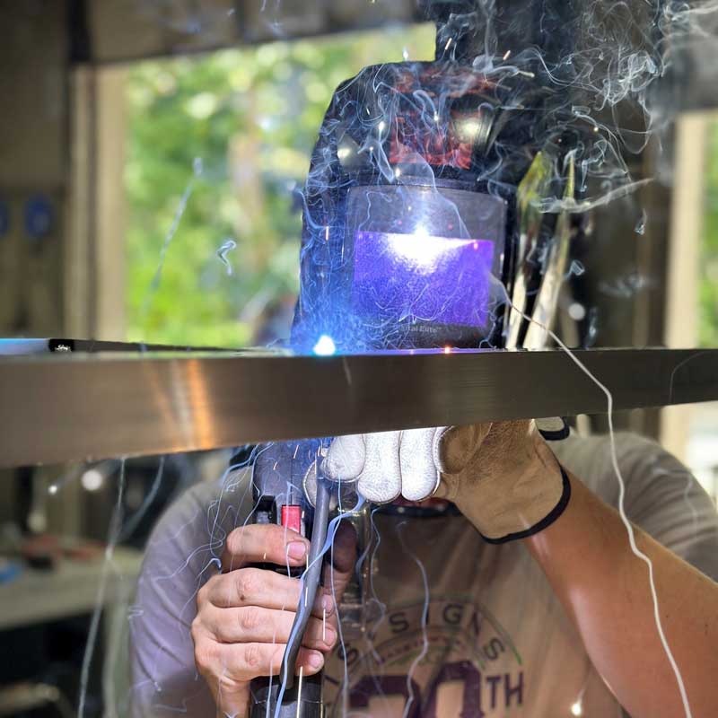 Paris-Signs-employee-welding-sign-pieces-together